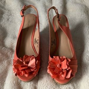 Peach colored wedges with flower on toe and cork heel and gold accents